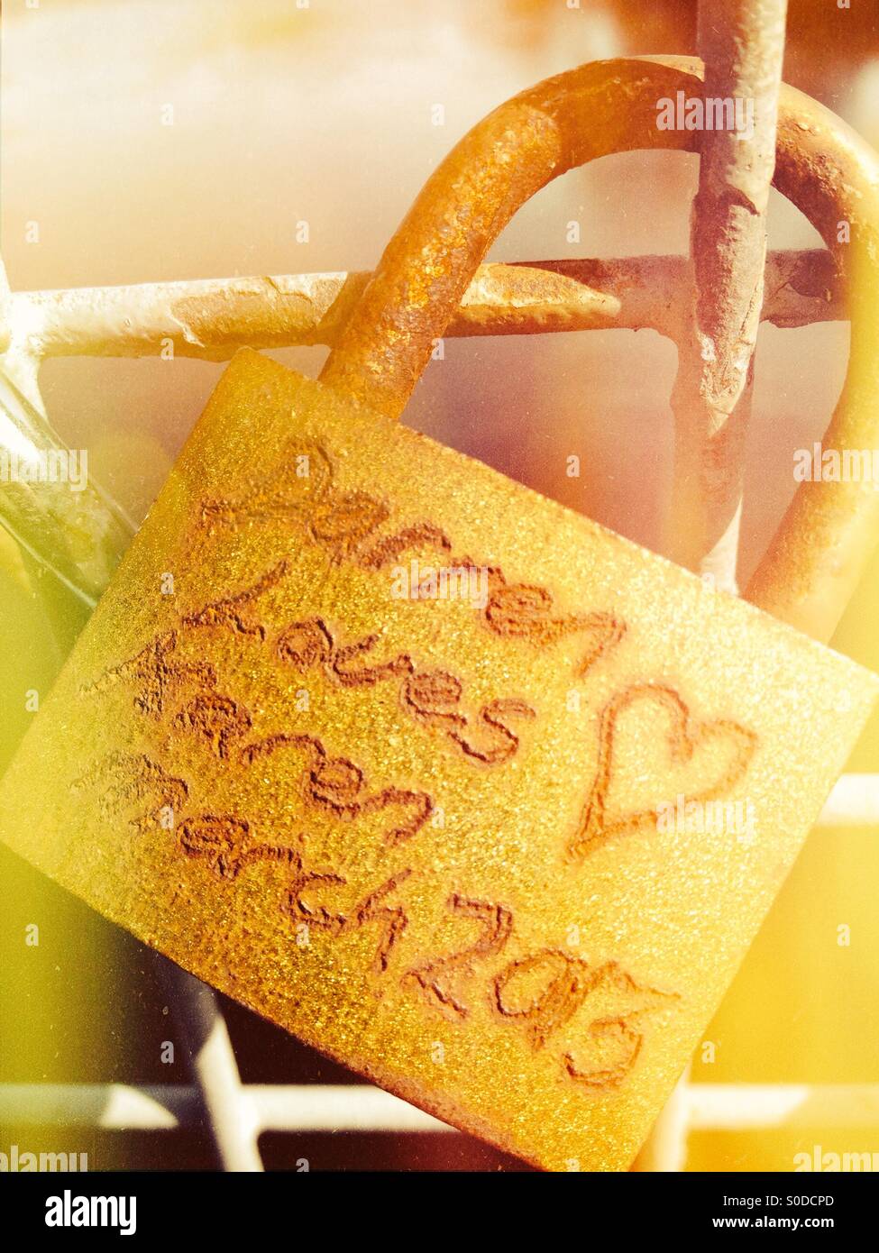 Love locks on a bridge over the river wharf at otley Yorkshire - Smartphone Captured Stock Image