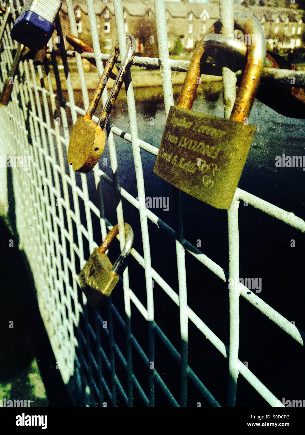 Love locks on a bridge over the river wharf at otley Yorkshire - Smartphone Captured Stock Image