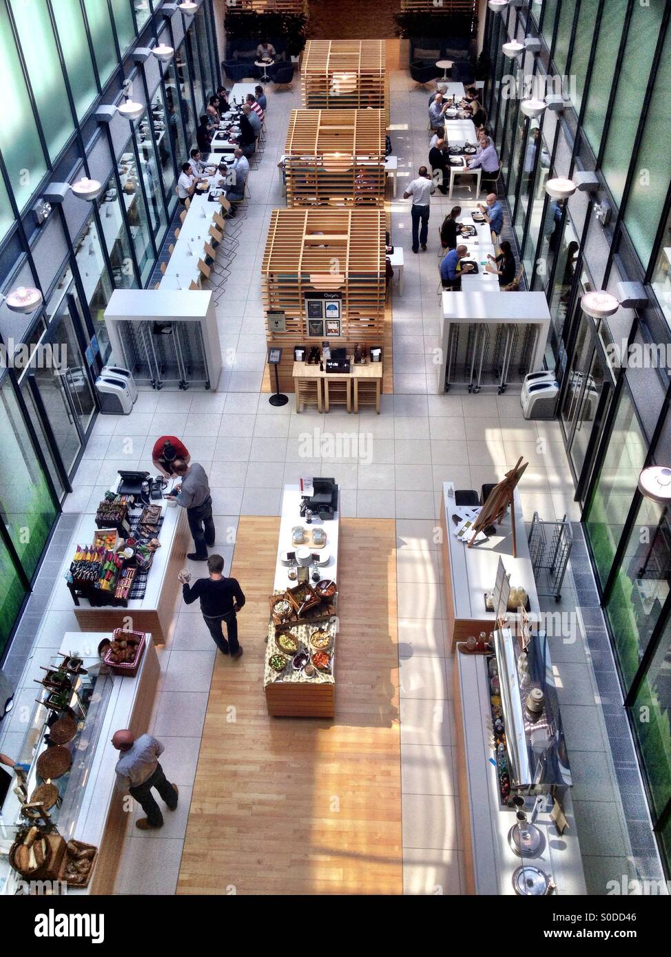 Looking down at people buying food and eating in the office canteen - Smartphone Captured Stock Image