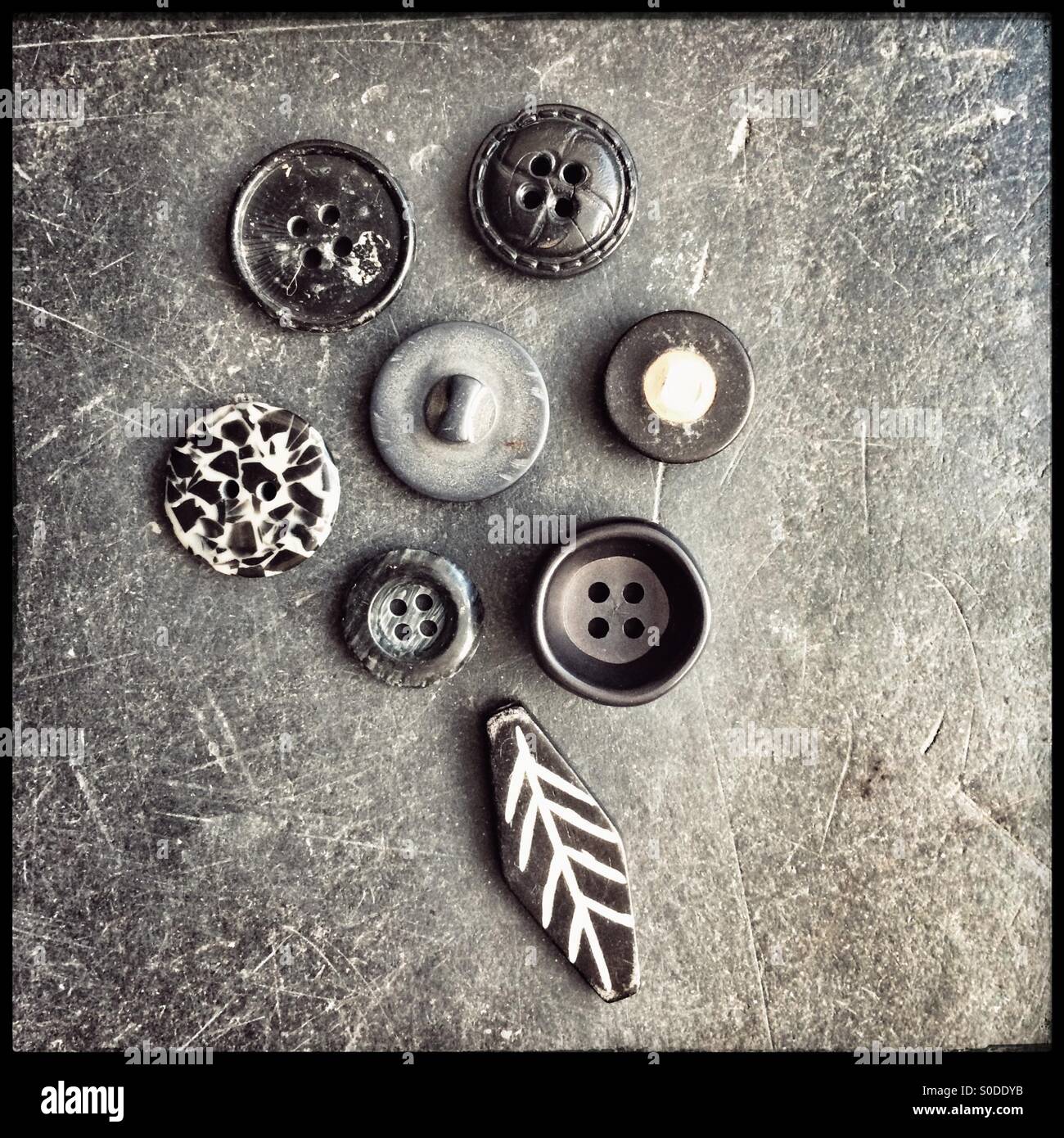 Monochrome abstract flower design with beads and buttons. - Smartphone Captured Stock Image