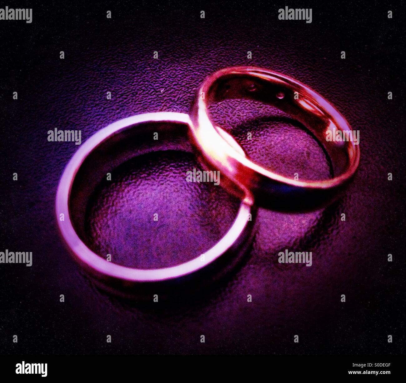 Two rings.. A wedding ring and a signet ring . - Smartphone Captured Stock Image