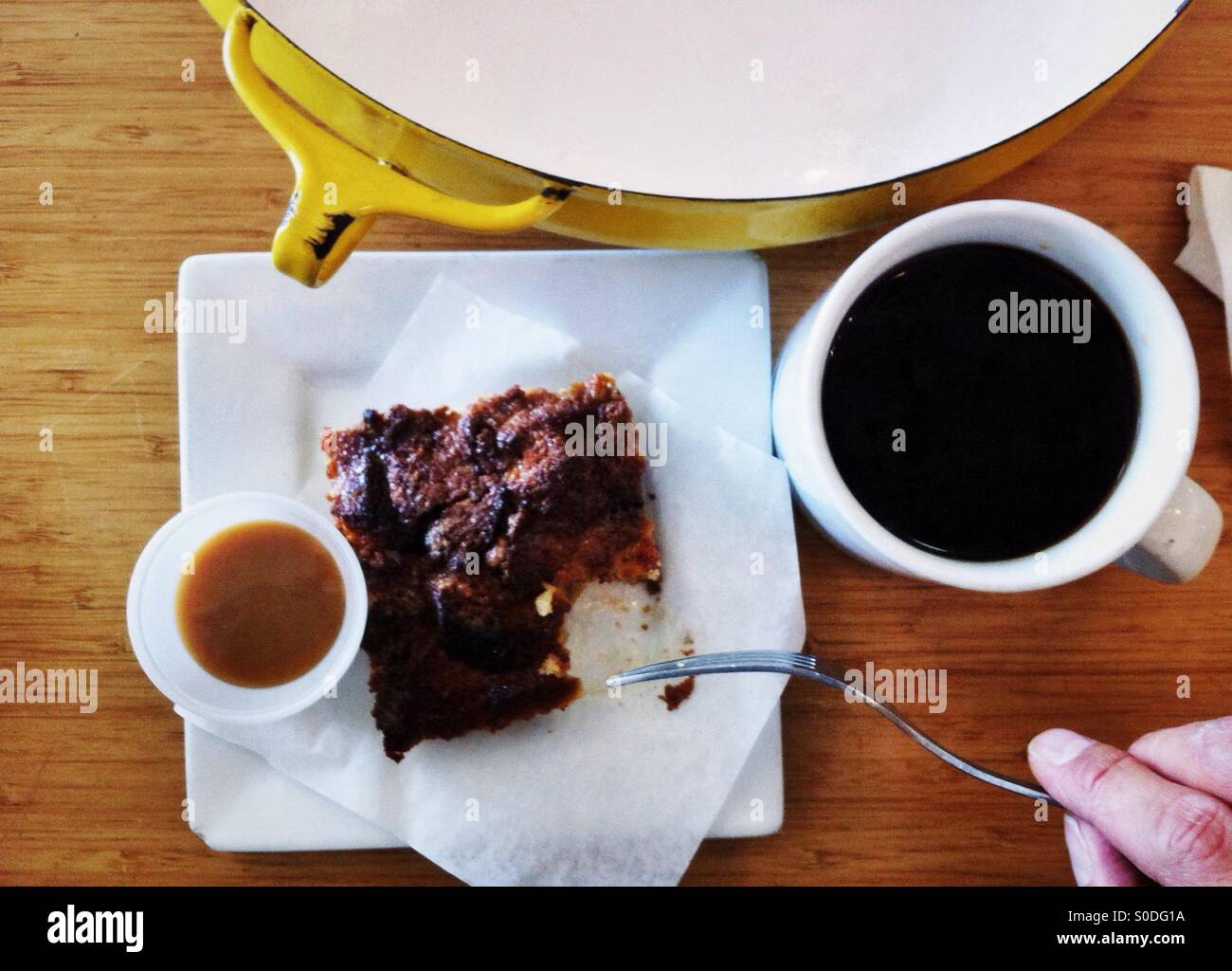 Bread pudding with caramel sauce on the side and coffee - Smartphone Captured Stock Image