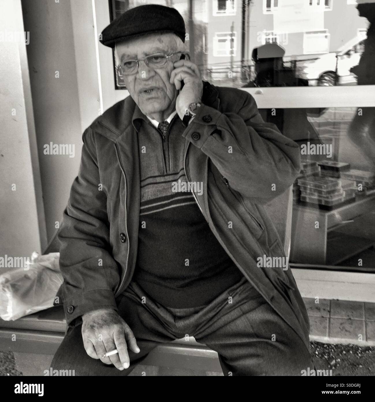 Older man speaking in his mobilephone Stock Photo