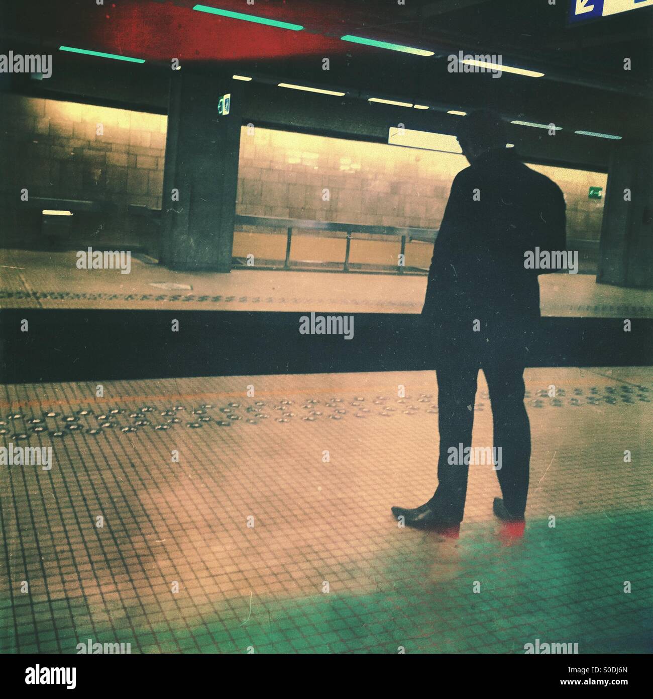 Silhouette of a man standing in a subway station - Smartphone Captured Stock Image