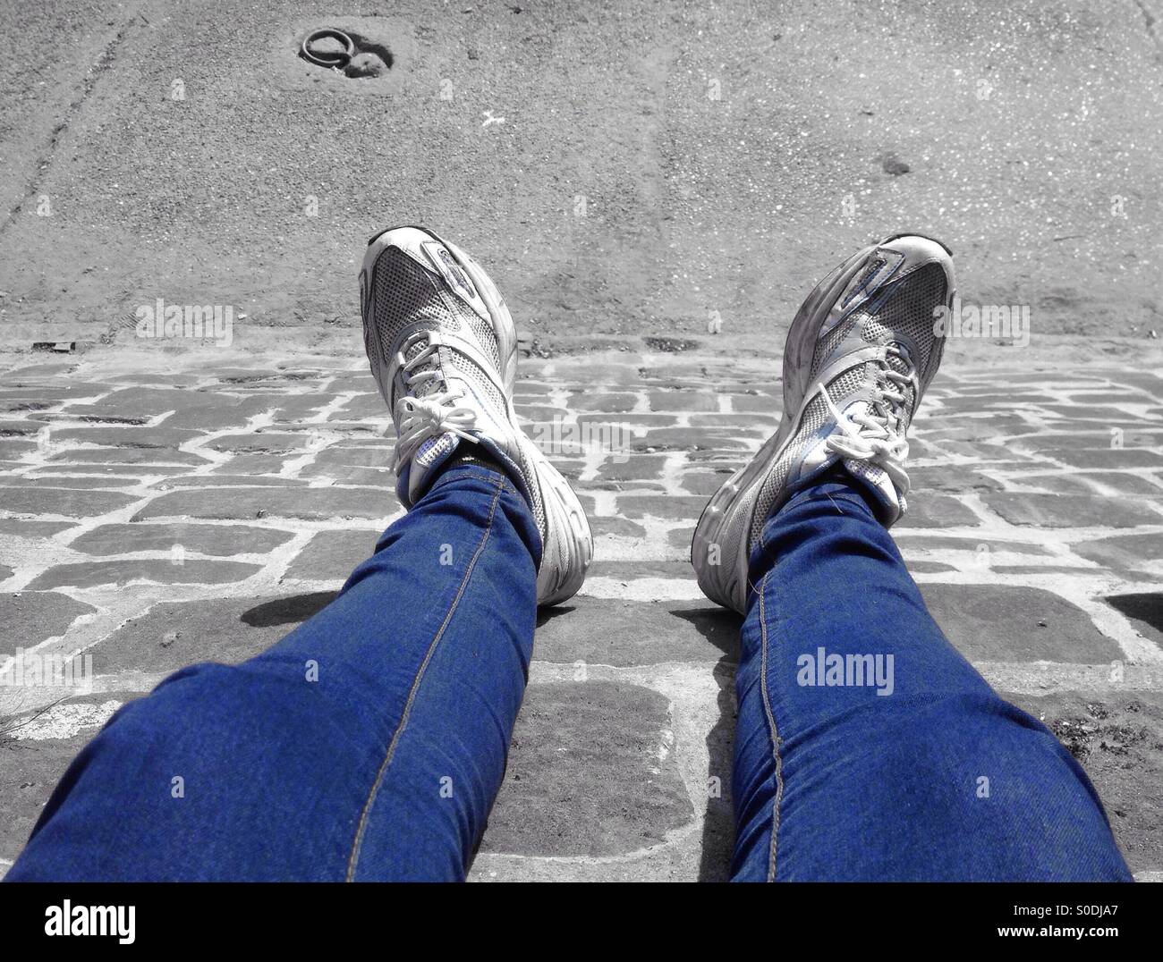 Feet hanging down over a wall Stock Photo Alamy