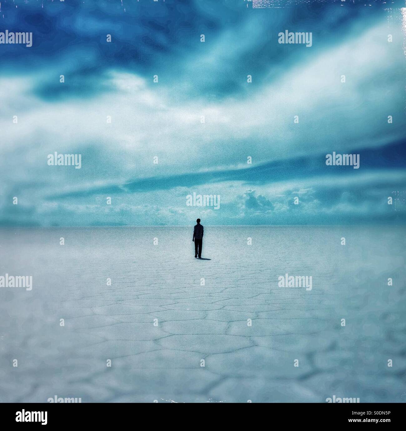 A tourist walks through the salar Uyuni in Bolivia - Smartphone Captured Stock Image