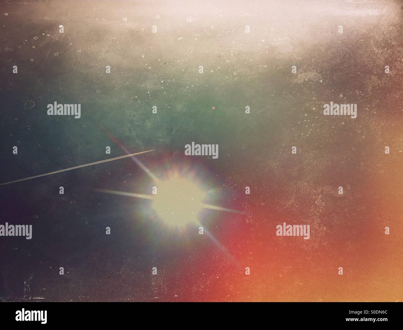 Plane trail going over sun beams - Smartphone Captured Stock Image