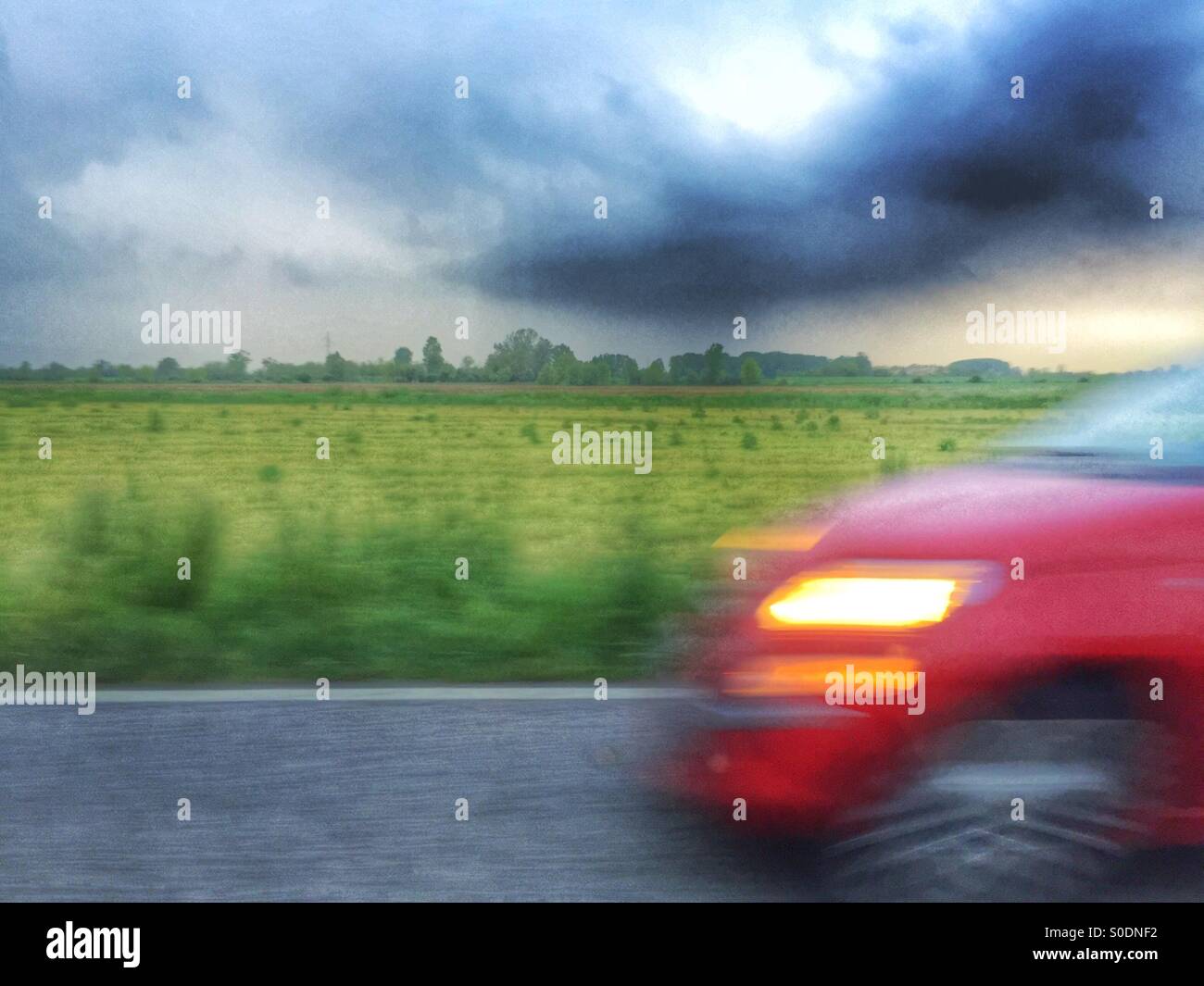 Stormy sunset on the road Stock Photo - Alamy