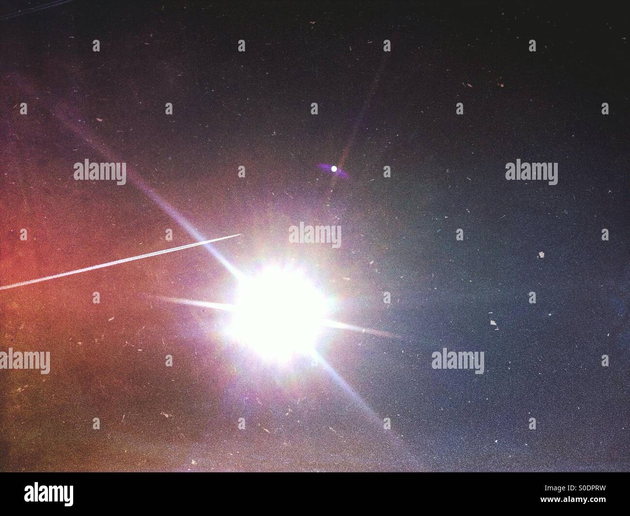 Plane trail over sun - Smartphone Captured Stock Image