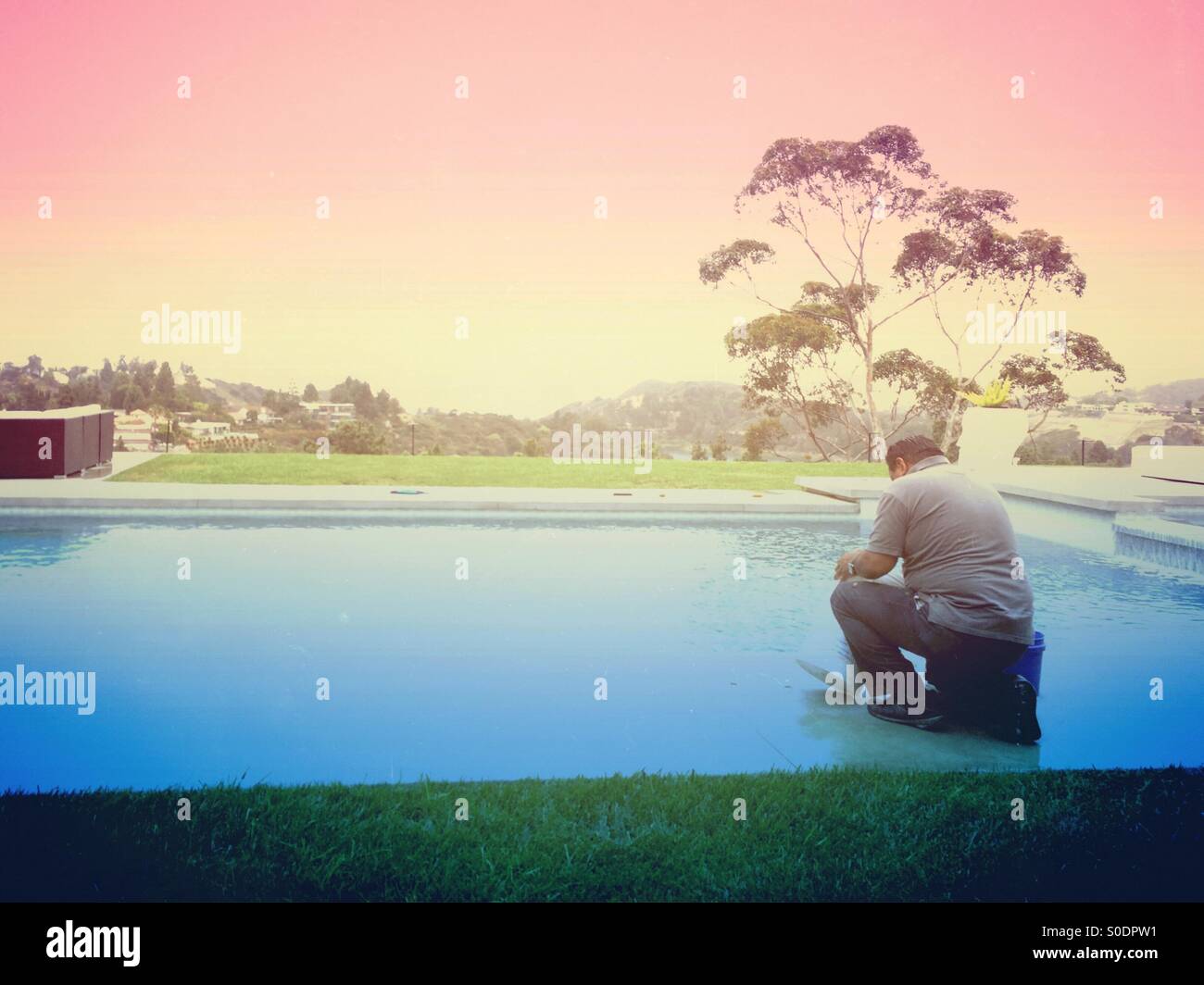 Pool guy working on Hollywood pool. - Smartphone Captured Stock Image