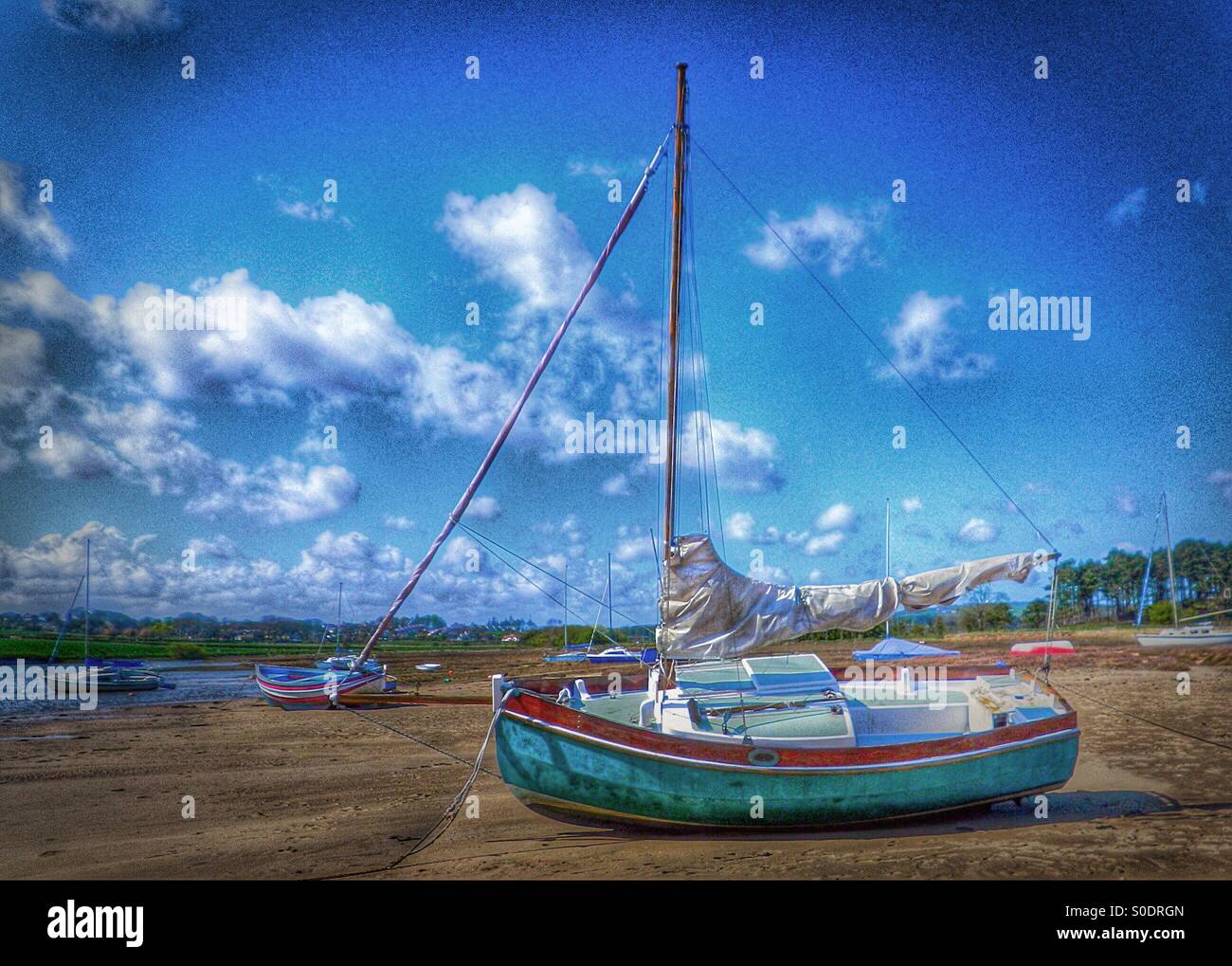 Small yacht when the tide is out, Northumberland, England - Smartphone Captured Stock Image