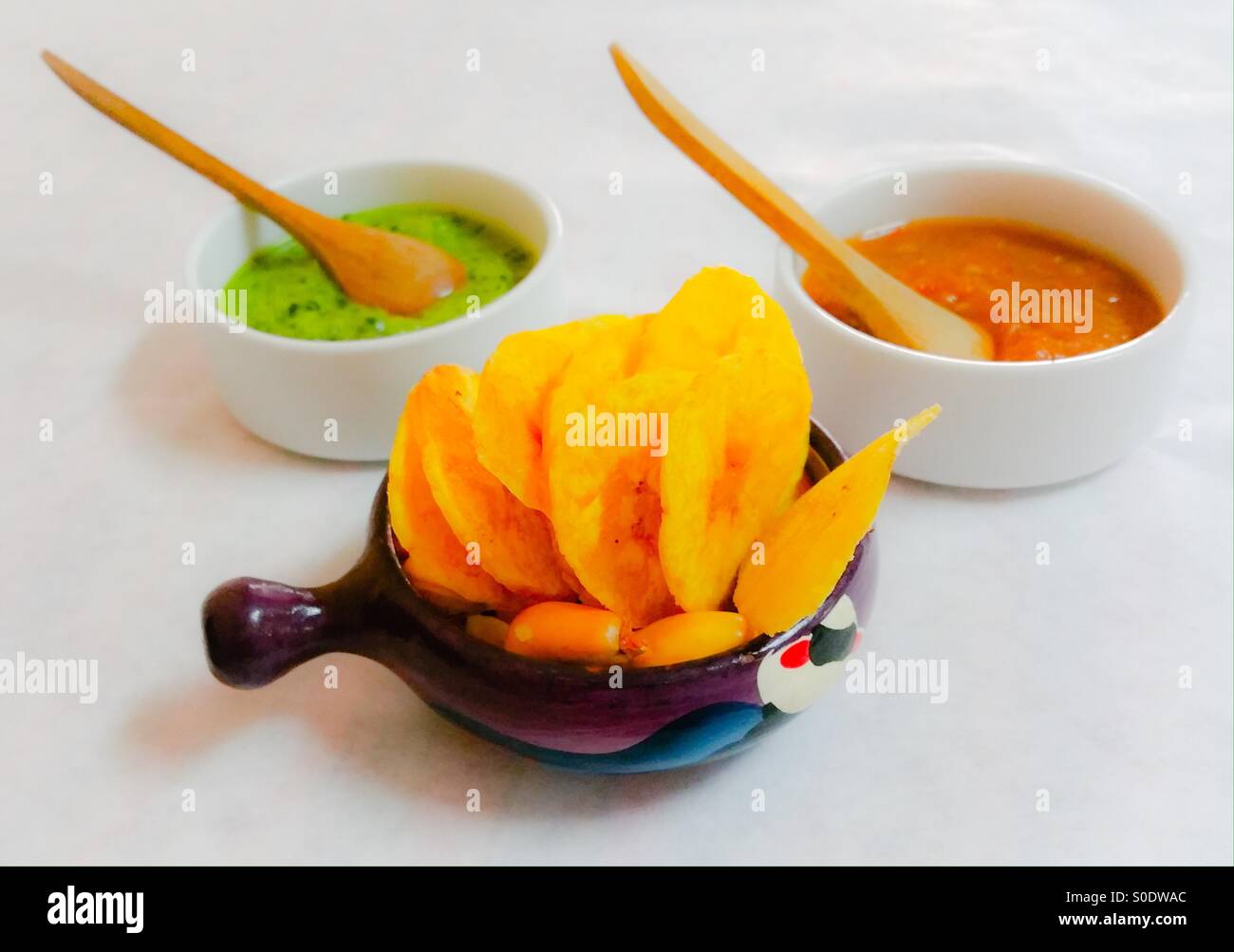 Plantain Chips, Corn Nuts with Green and Red Chile Salsas - Smartphone Captured Stock Image