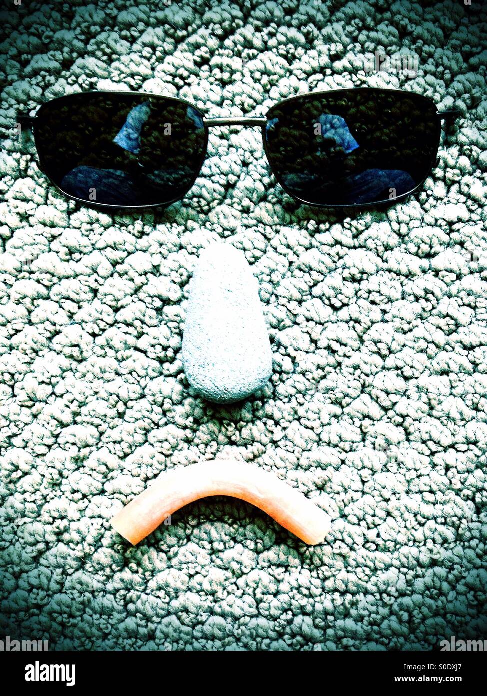 Abstract sad face with sunglasses - Smartphone Captured Stock Image