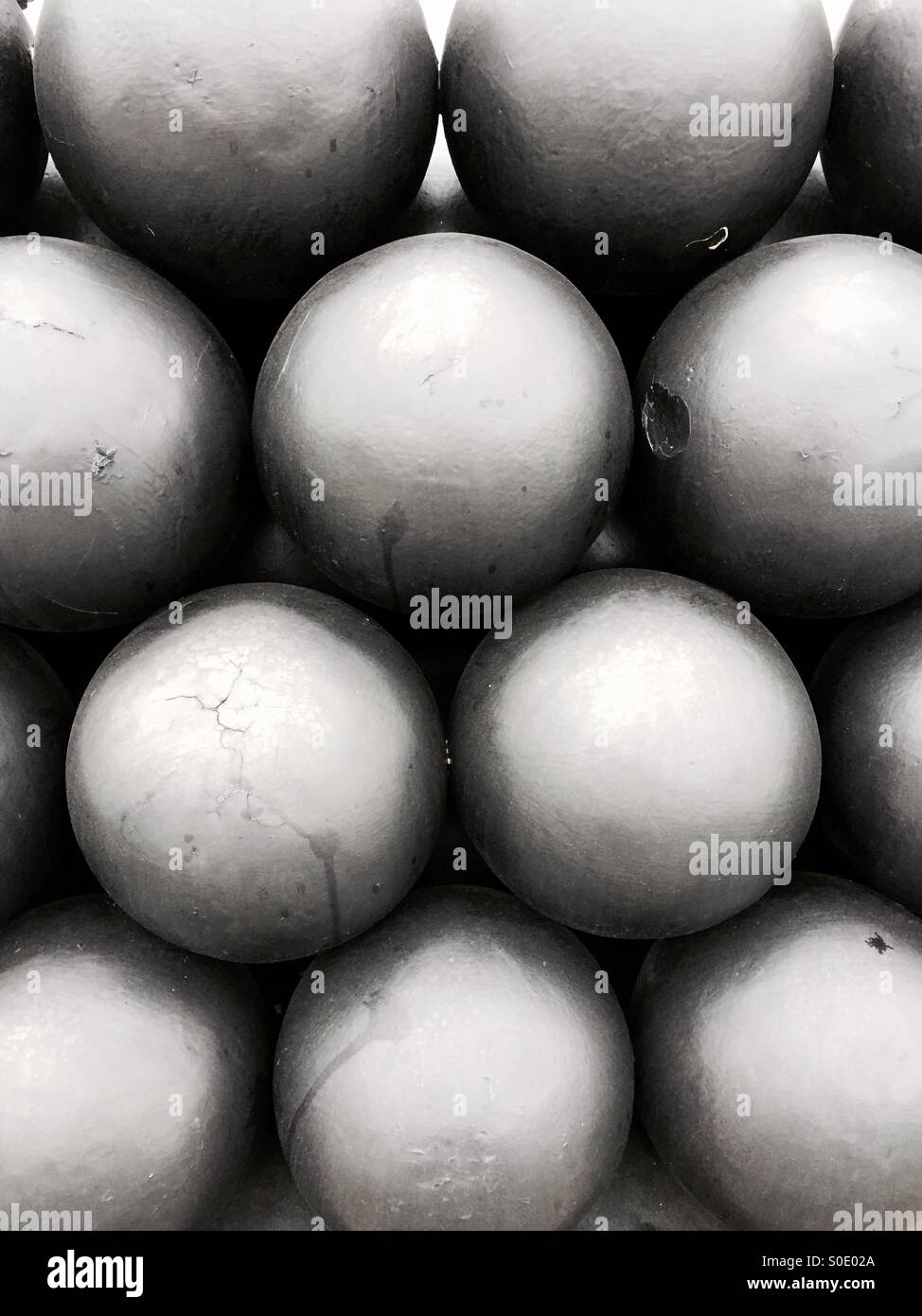 Cannonballs neatly stacked into pattern - Smartphone Captured Stock Image