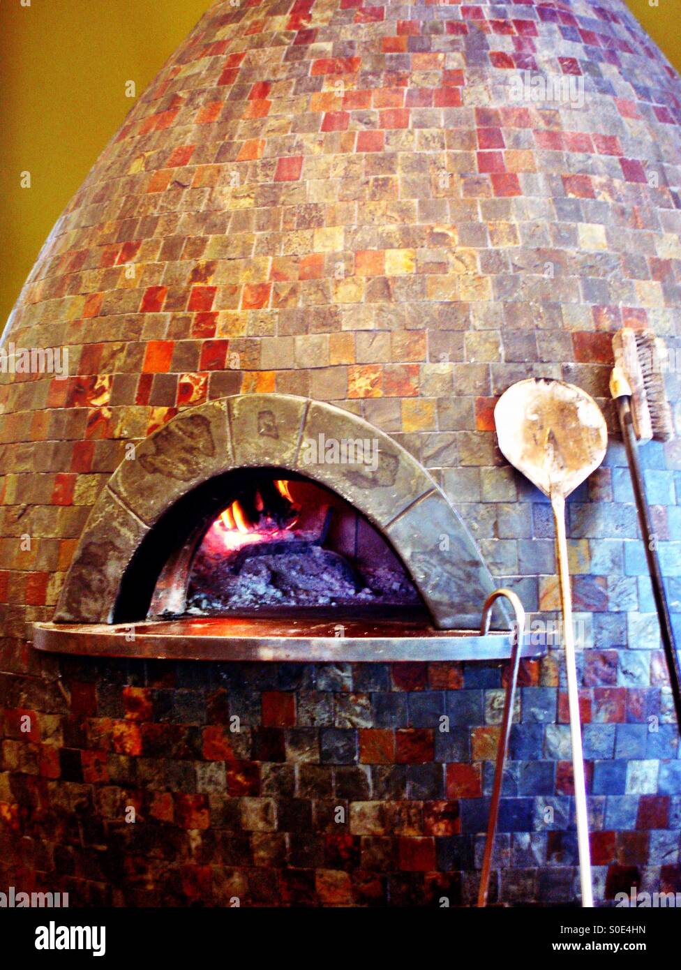 Fiery conical rustic brick baking oven - Smartphone Captured Stock Image