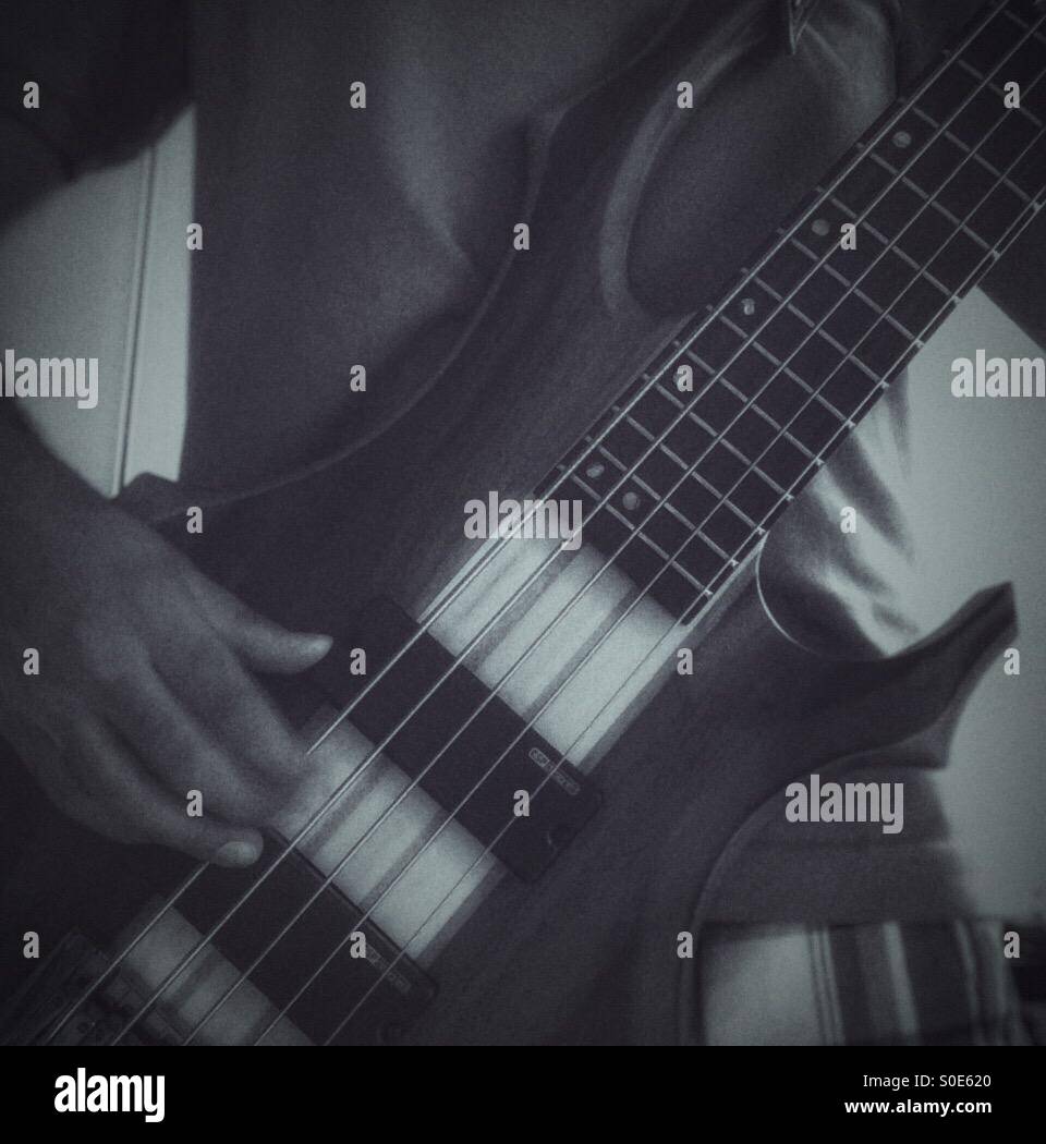 A guy playing bass guitar. - Smartphone Captured Stock Image