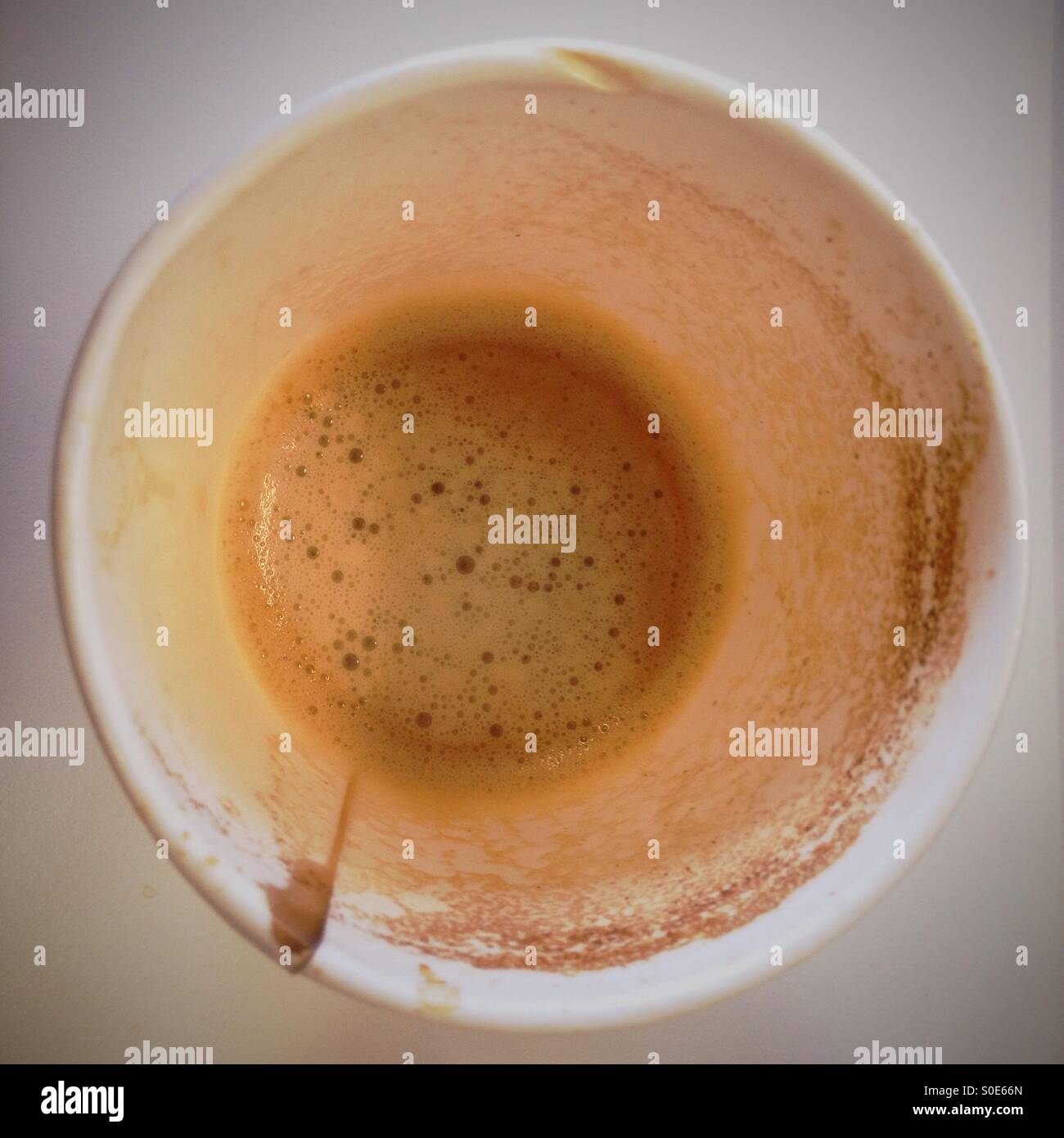 A half drunk cup of coffee from a coffee machine. - Smartphone Captured Stock Image
