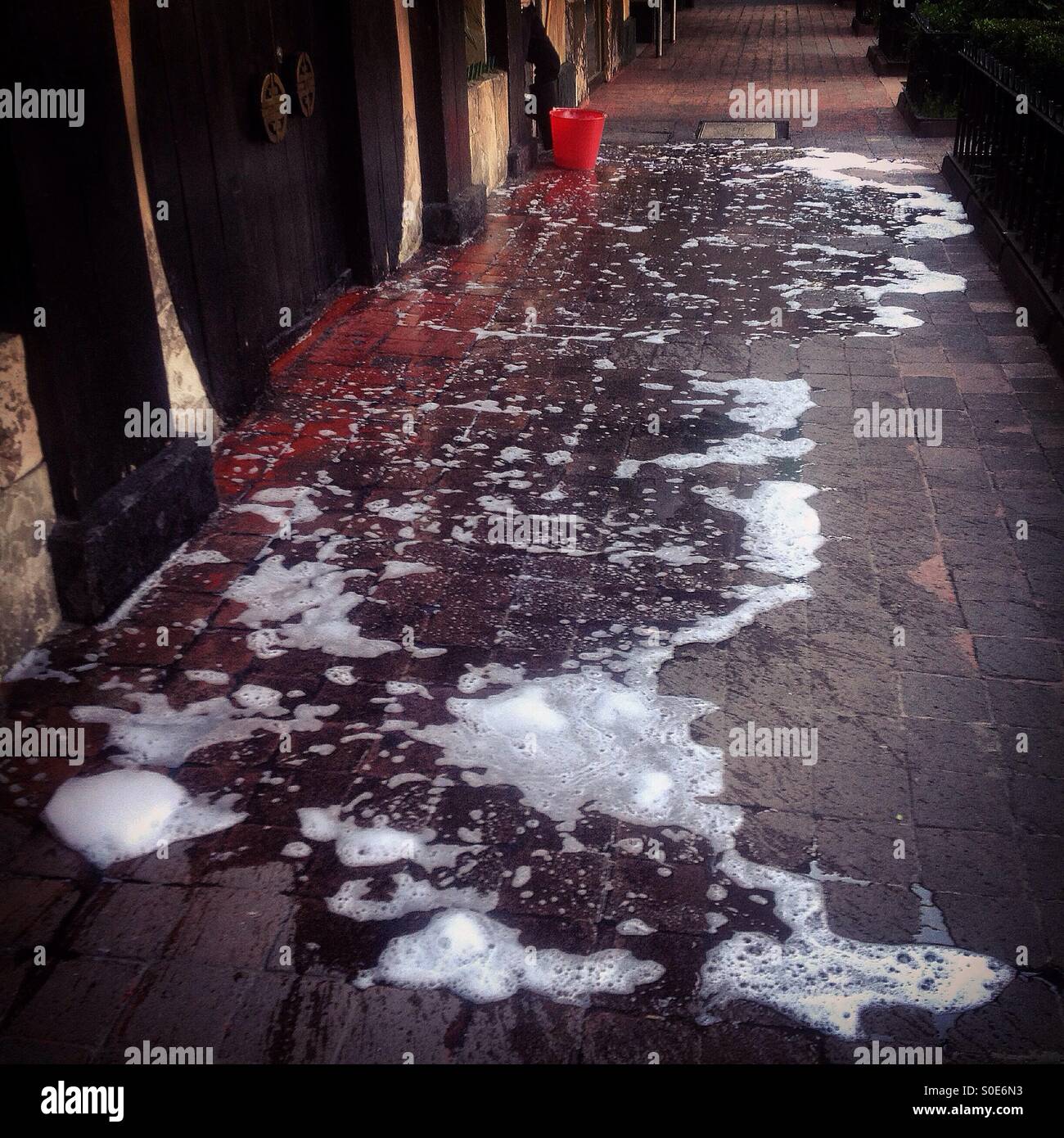 Detergent fills a sidewalk in Zona Rosa neighborhood, Mexico City, Mexico - Smartphone Captured Stock Image