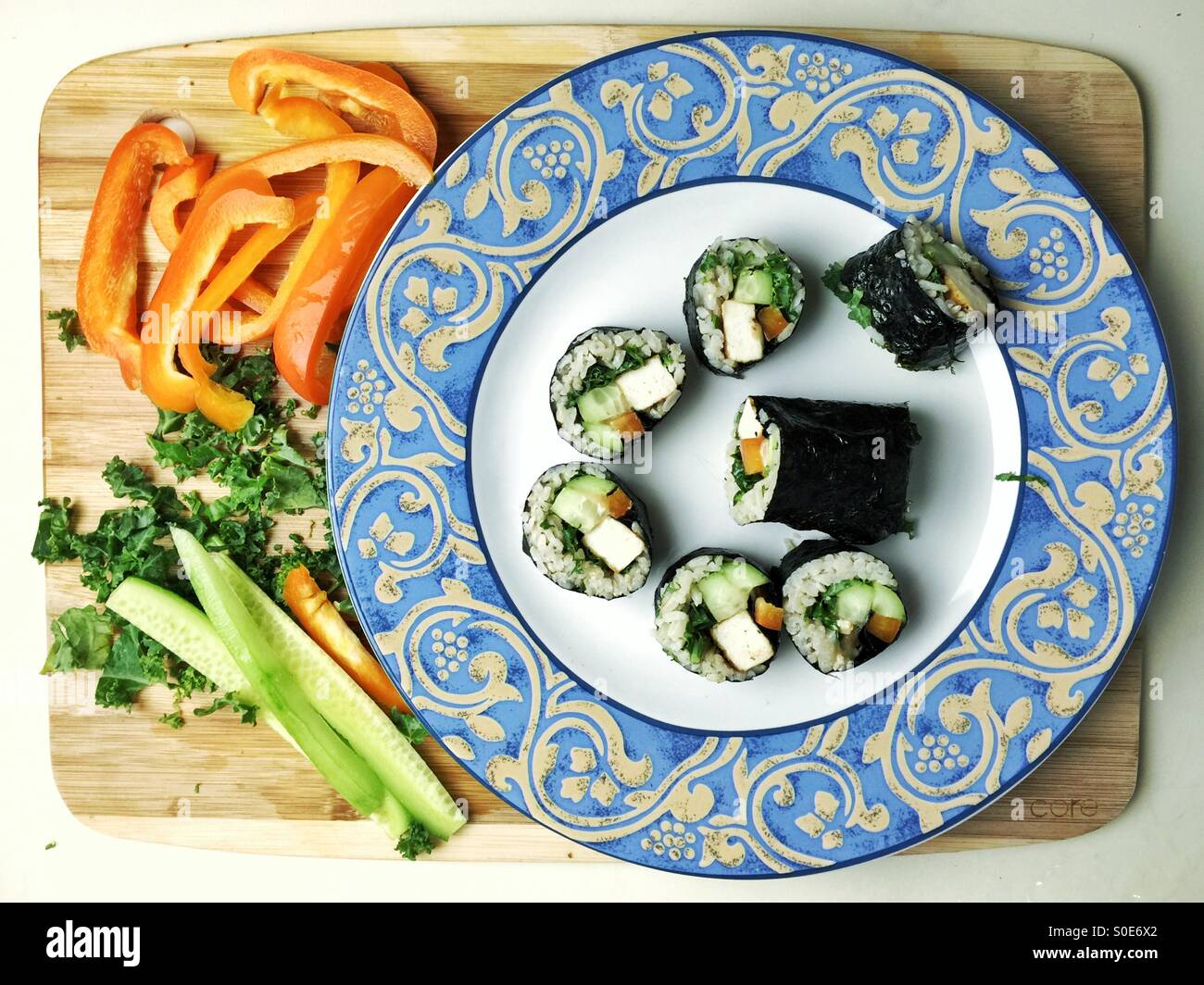 vegetarian Nori rolls on a plate with chopped vegetables - Smartphone Captured Stock Image