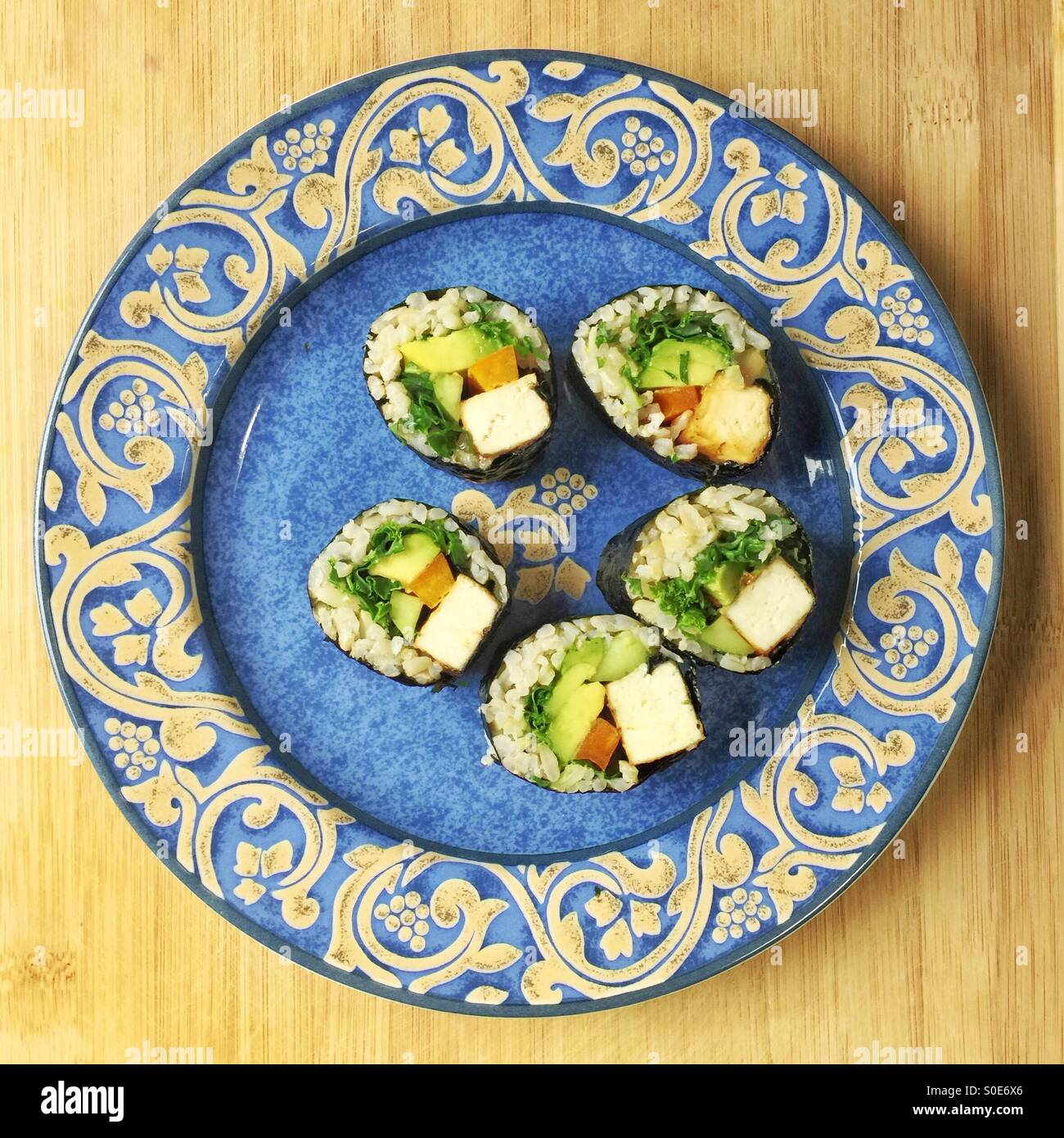 five tofu nori rolls on blue plate Stock Photo