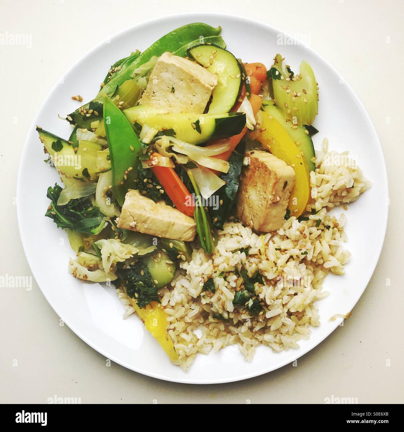 vegan tofu stir fry with brown rice - Smartphone Captured Stock Image