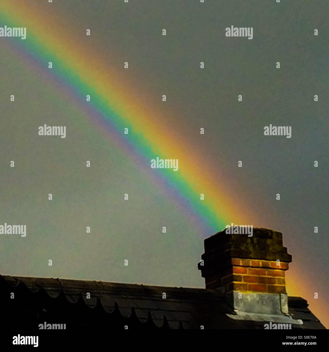 Rainbow over chimney pot Stock Photo