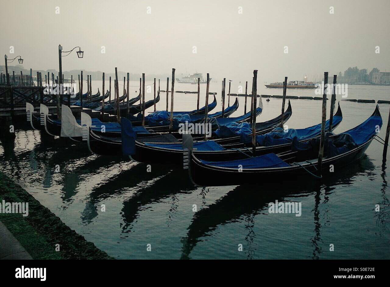 Gondolas moored at the pier in the early morning in Venice, Italy - Smartphone Captured Stock Image
