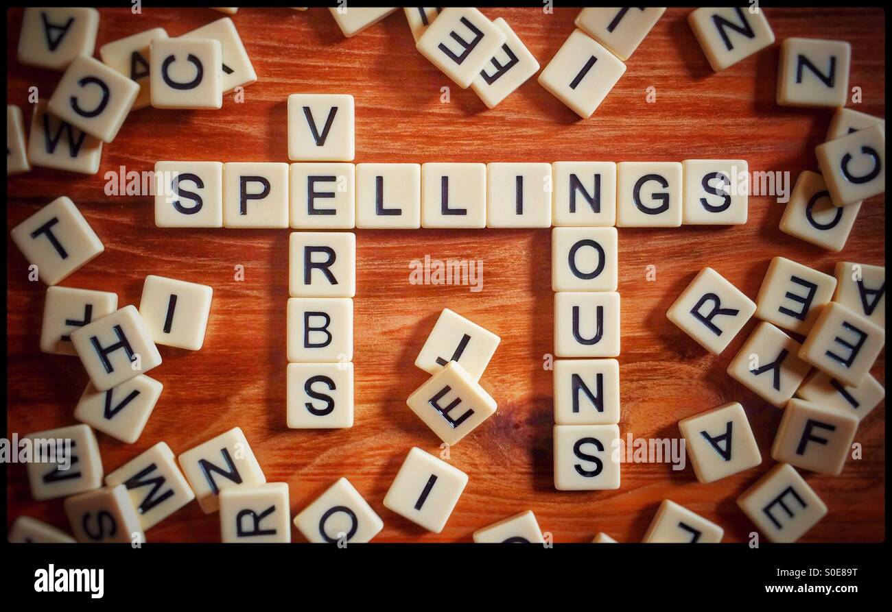 The words SPELLINGS, VERBS, & NOUNS spelt out using letter tiles Stock