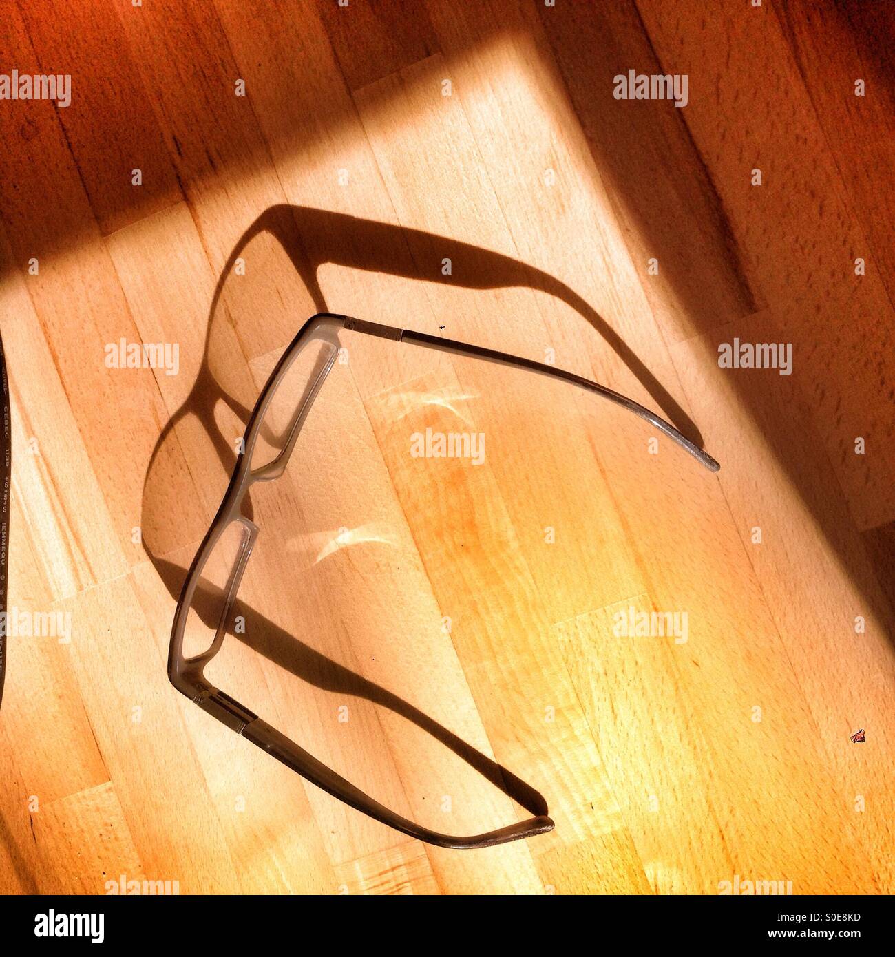Spectacles and shadow Stock Photo - Alamy