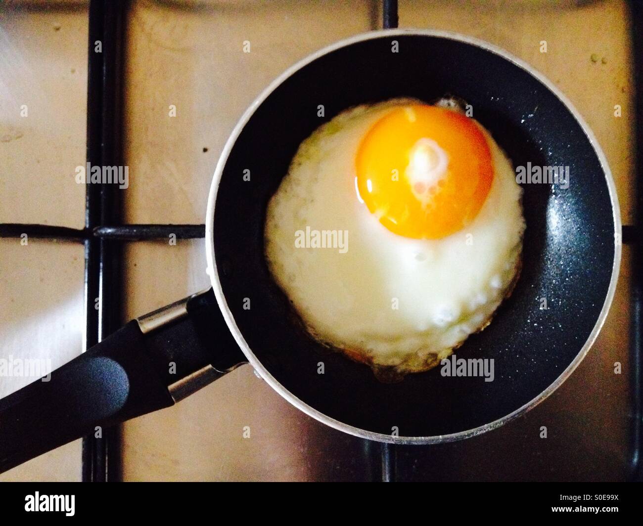 Organic free-range fried egg in single egg frying pan Stock Photo - Alamy