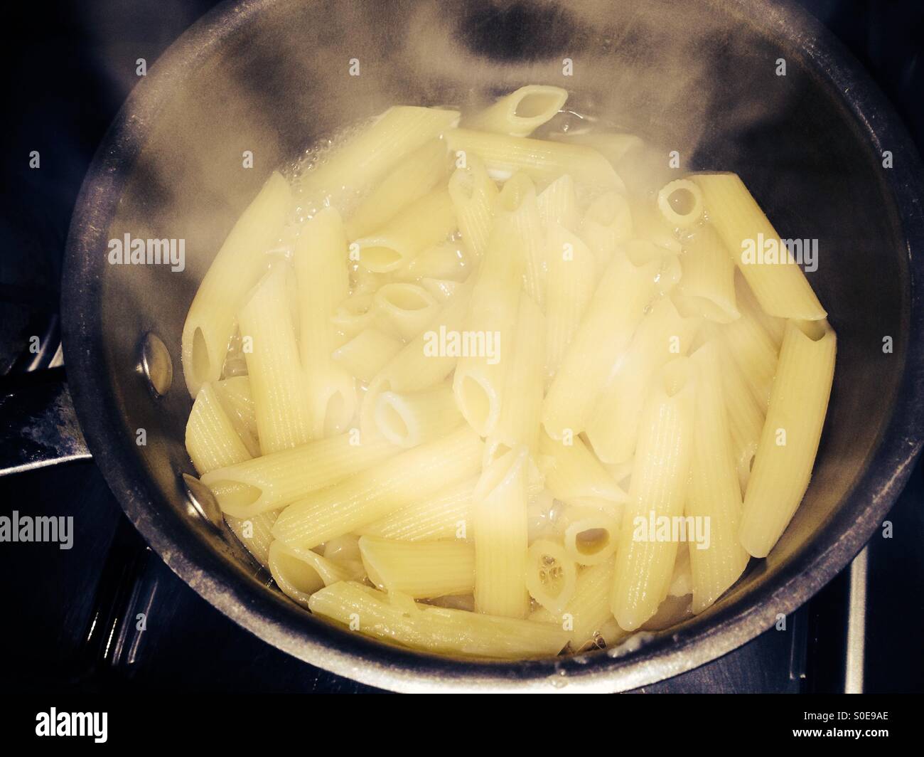 Penne Rigate pasta in saucepan - Smartphone Captured Stock Image