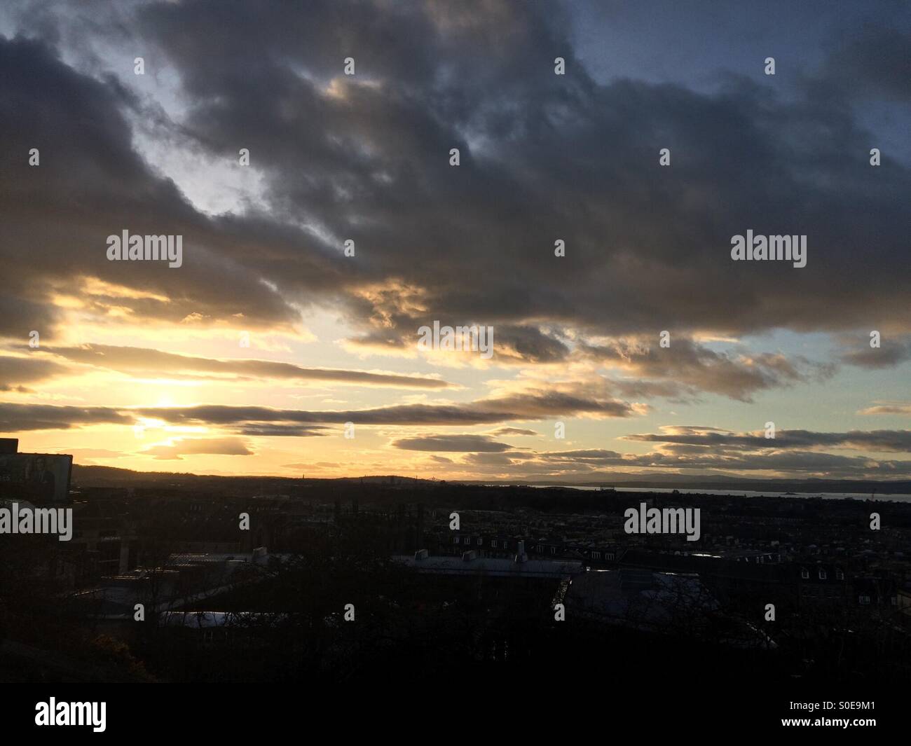 Sunset at Edinburgh city. View of the sky and dark city below Stock Photo