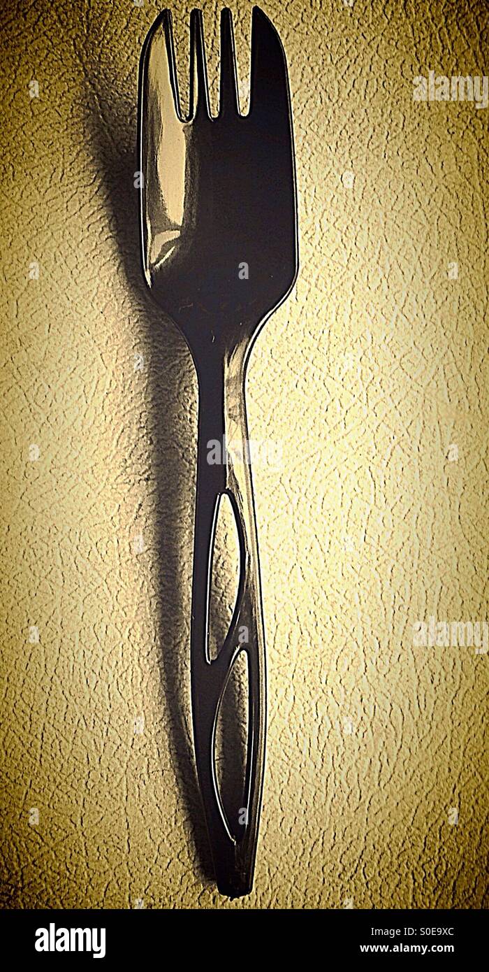 Plastic Spork, a disposable utensil which is a combination of a spoon and a fork Stock Photo