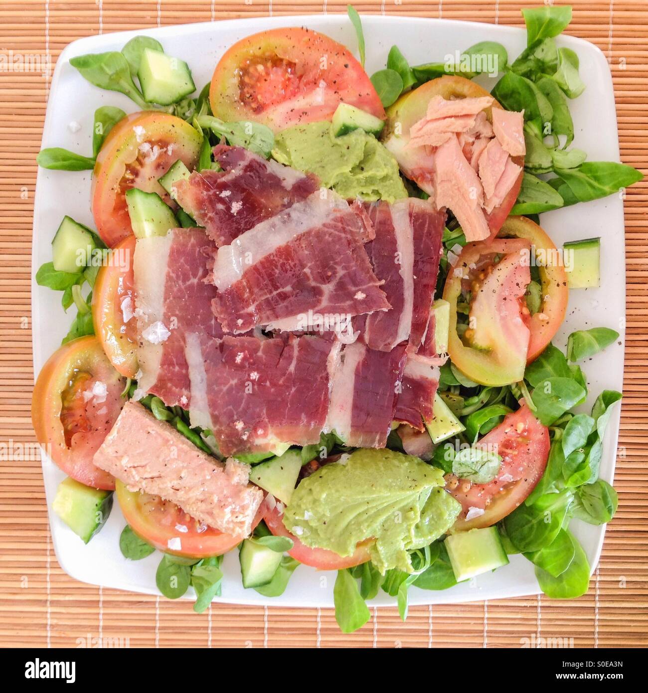 Ham and Tuna salad from above on a wicker place mat. - Smartphone Captured Stock Image