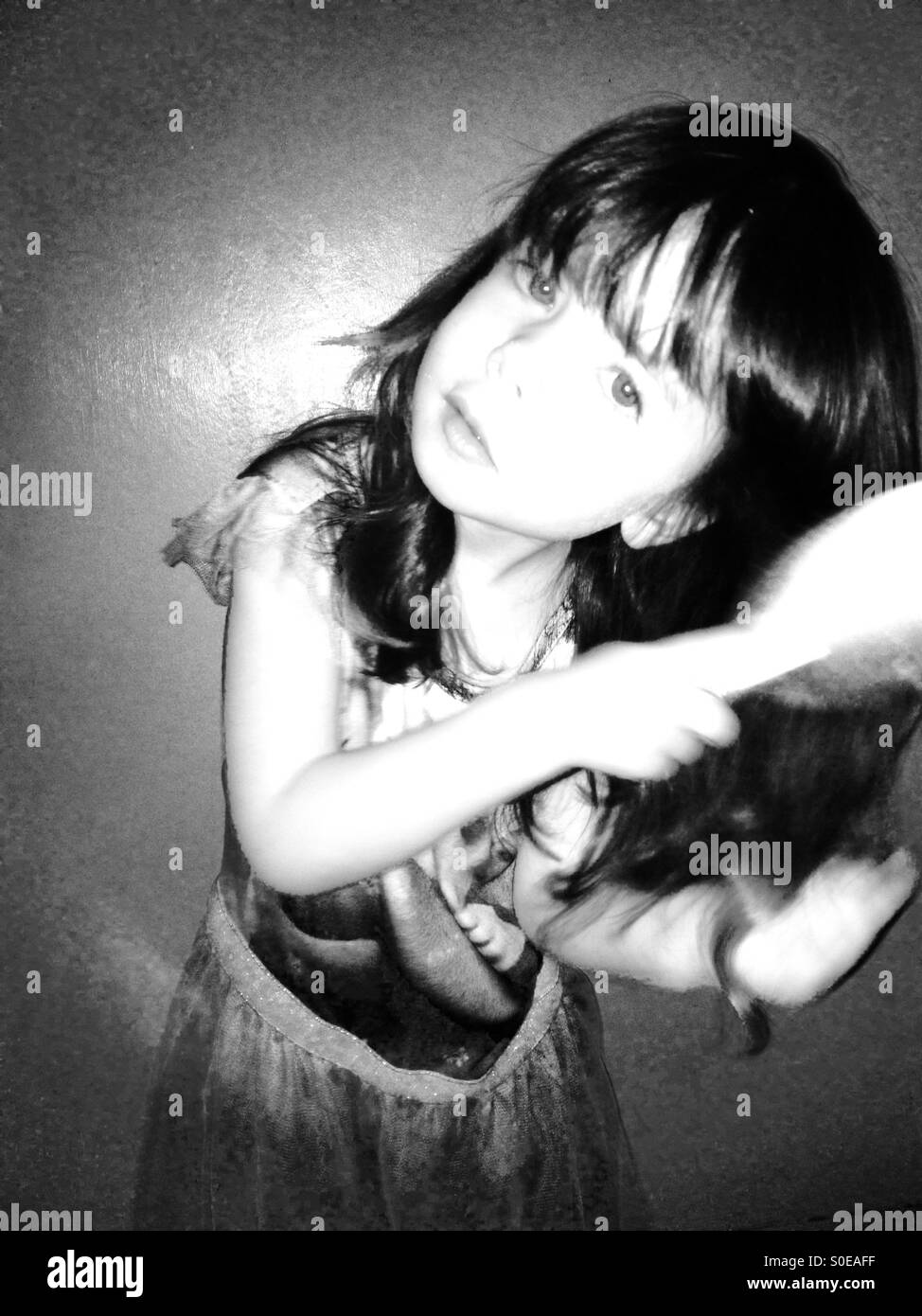 3-year old girl brushing her long hair - Smartphone Captured Stock Image