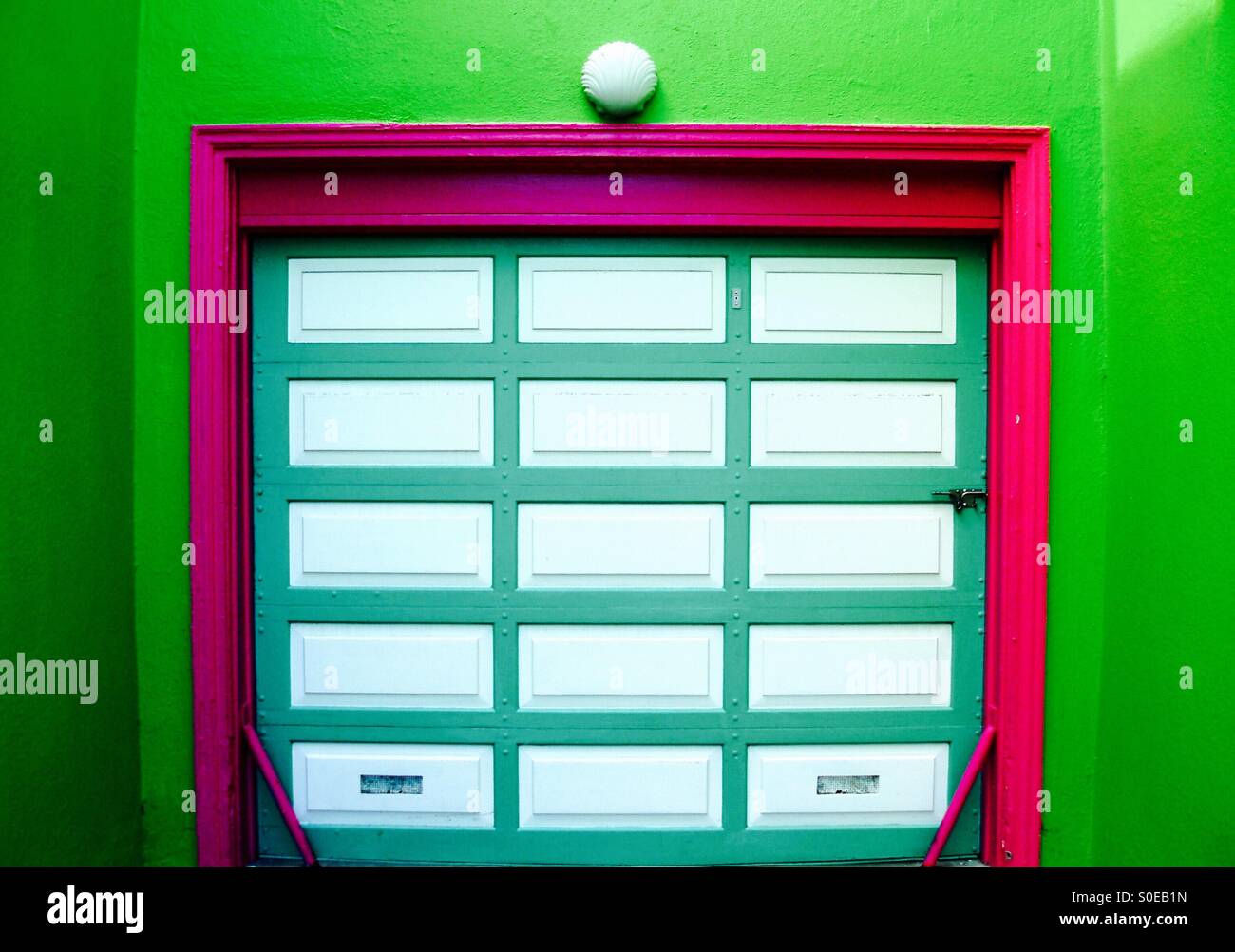 Shocking pink and green garage door Stock Photo