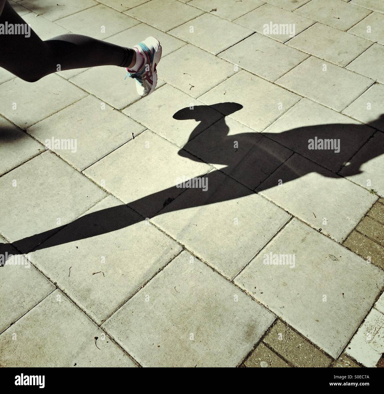 Shadow of an athlete who is running - Smartphone Captured Stock Image