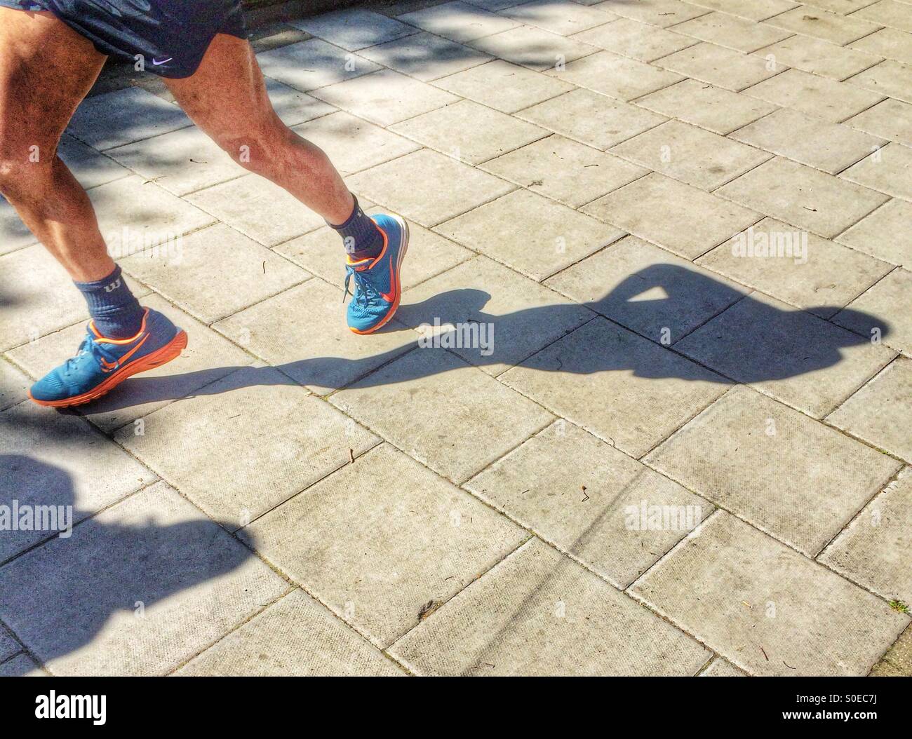 Shadow of a male running on the street - Smartphone Captured Stock Image