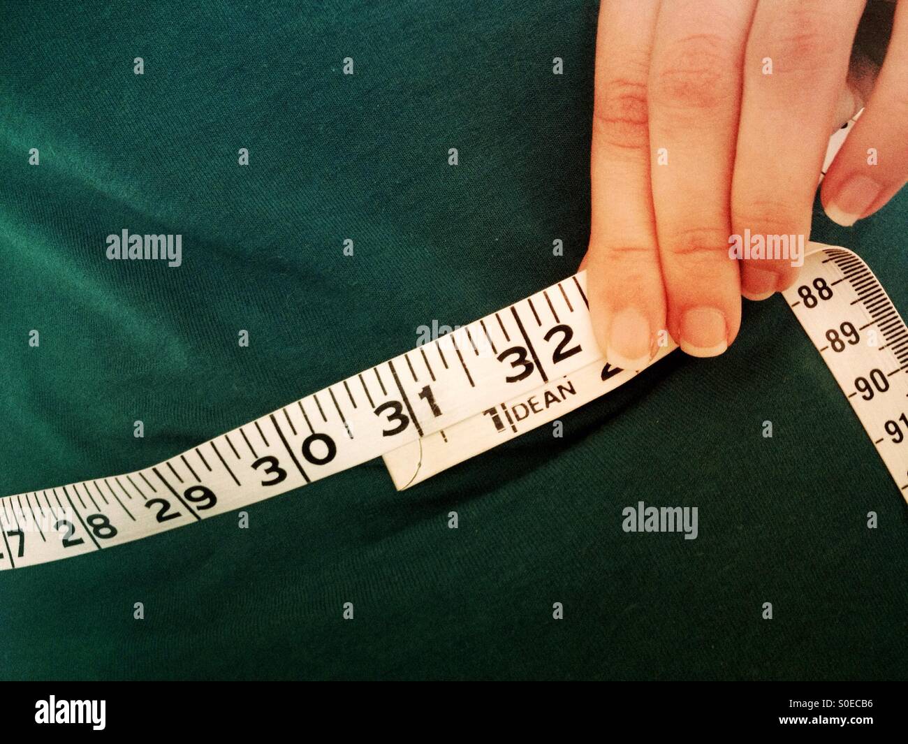 Woman measuring her waist Stock Photo