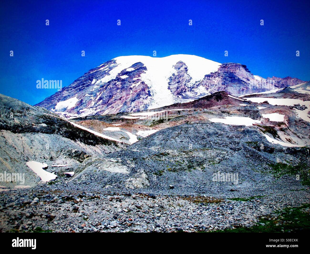 Summit ancient glacier, lava rock, mountain climbing under perfect clear blue skies - Smartphone Captured Stock Image
