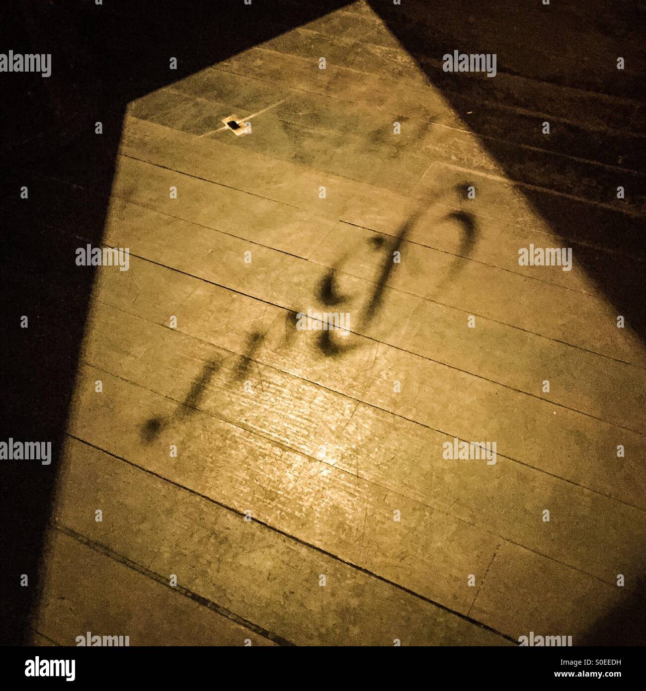 A shadow on the floor of a bar Stock Photo