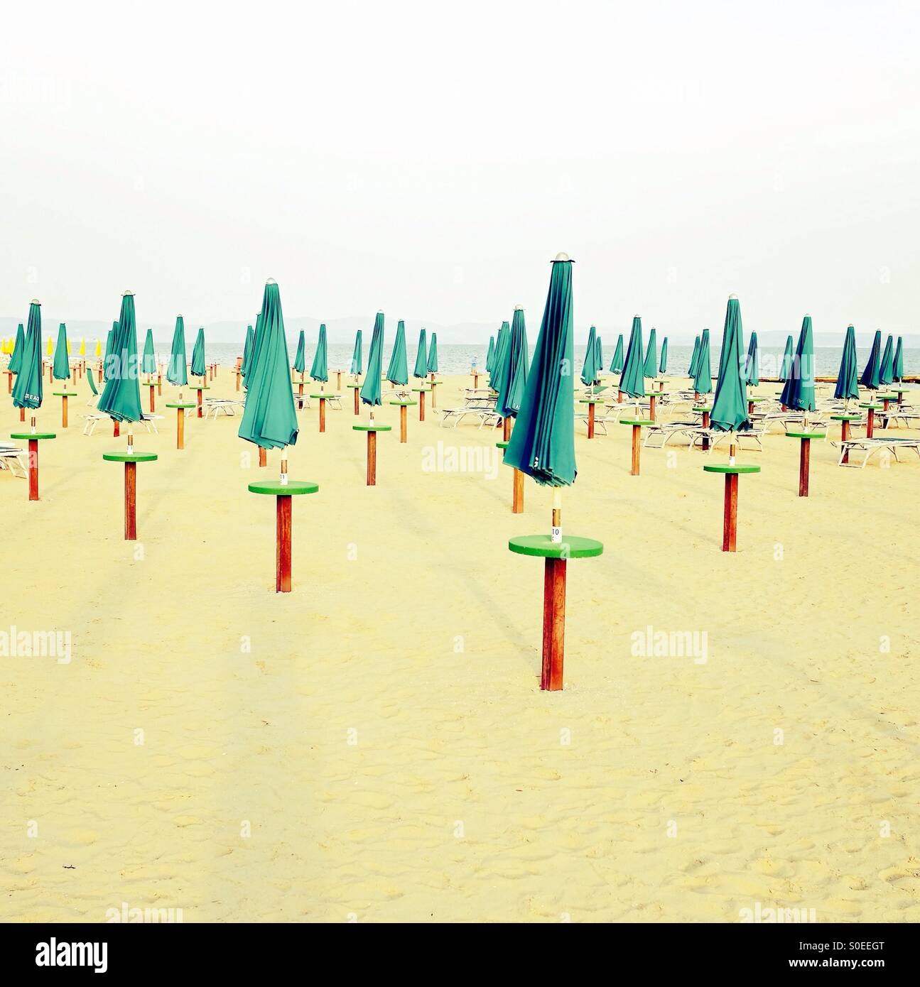 Closed beach umbrellas in Italy - Smartphone Captured Stock Image