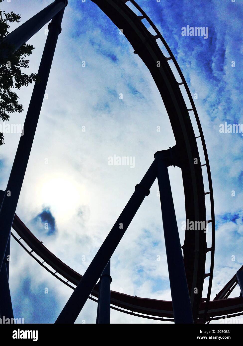 Silhouette of a roller coaster against a cloudy sky - Smartphone Captured Stock Image