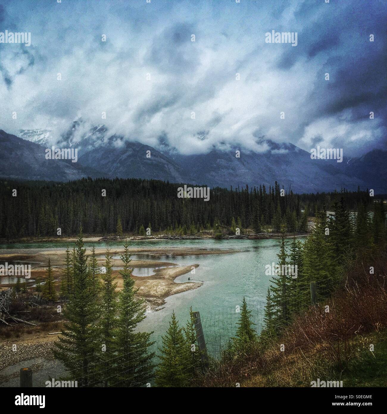 Emerald river flowing through northern Alberta, Canada near Banff- wilderness and fresh air! - Smartphone Captured Stock Image