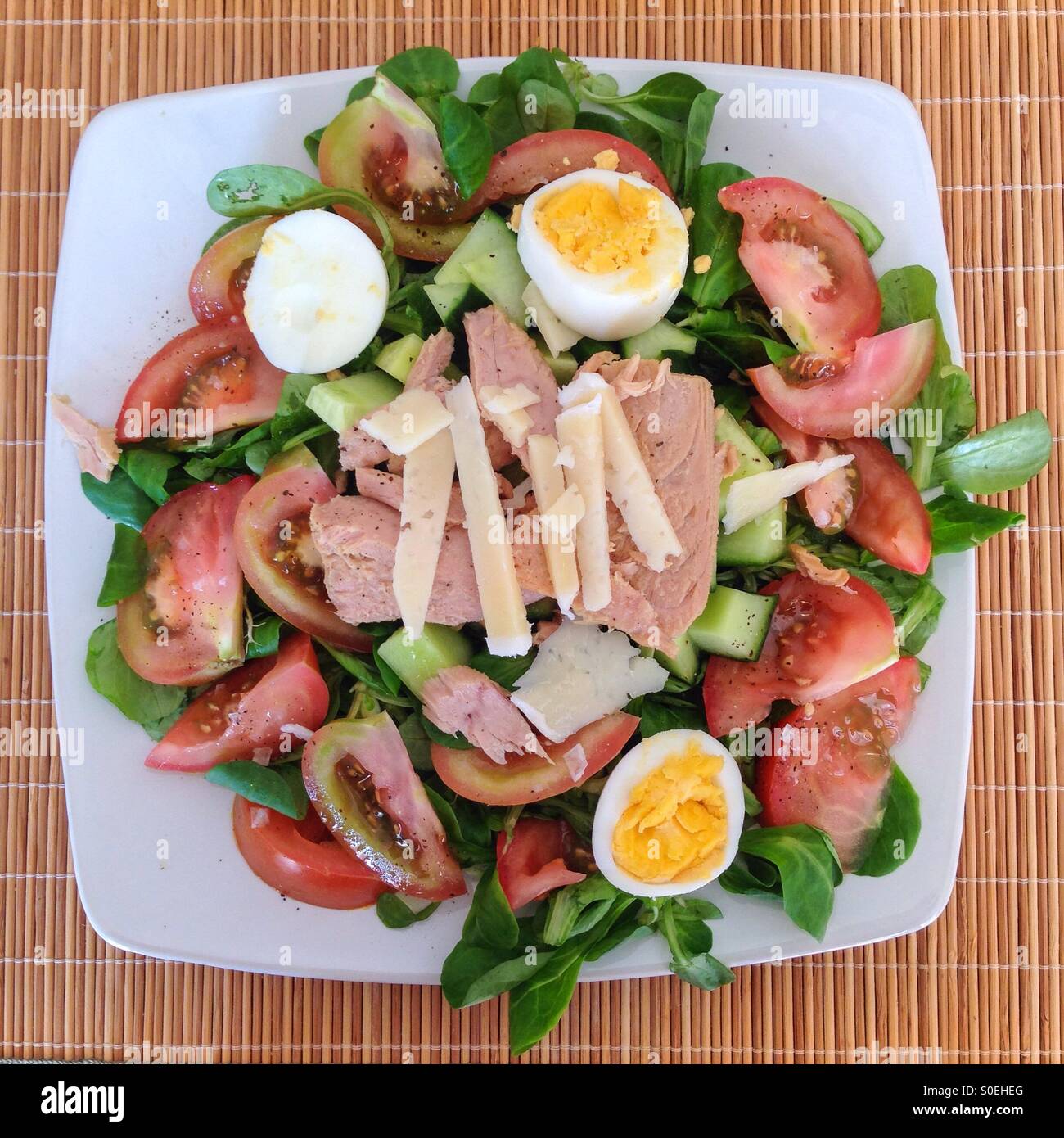 Tuna and egg salad from above on a wicker place mat. - Smartphone Captured Stock Image