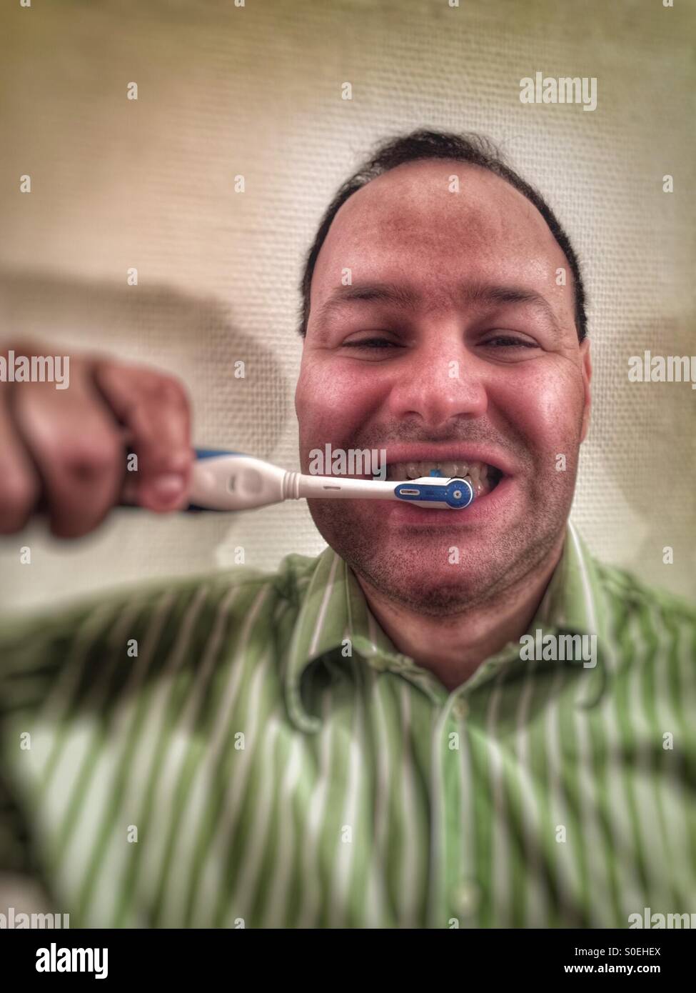 man brushing his teeth - Smartphone Captured Stock Image