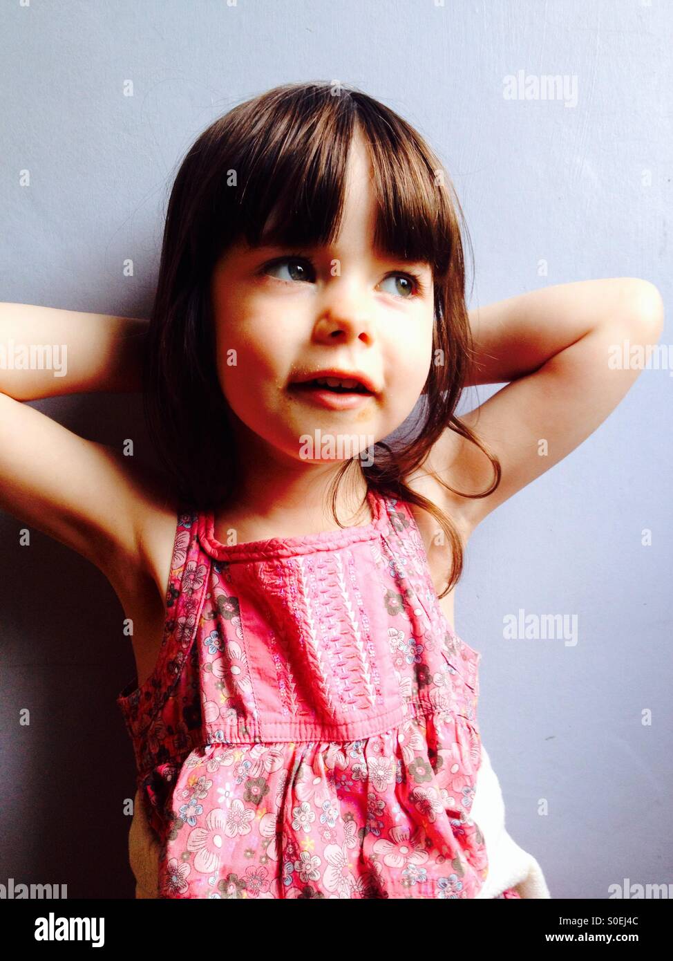 Happy 3-year old girl in pink dress - Smartphone Captured Stock Image