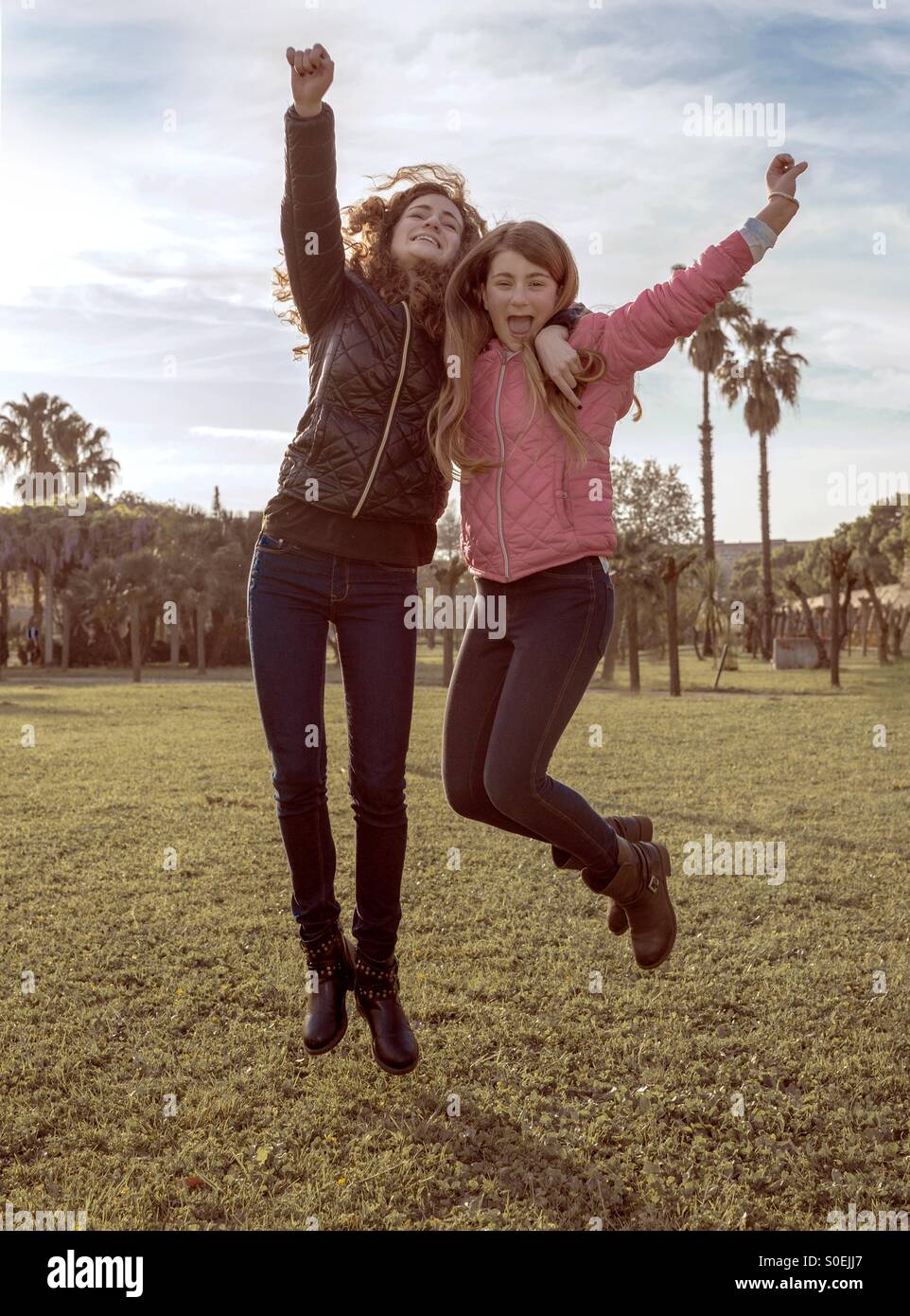 Two girls jumping Stock Photo