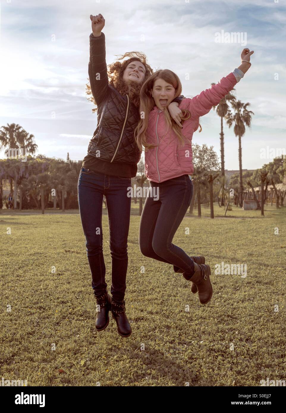 Two Girls Jumping High Resolution Stock Photography and Images - Alamy