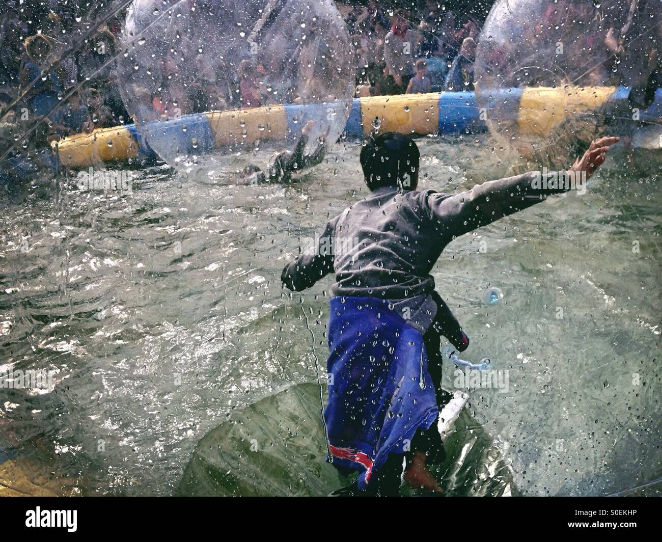 Water Fun At the children's Party of the carnival of Culture in Berlin Kreuzberg 2015 as Kids Play in Water Ballons - Smartphone Captured Stock Image